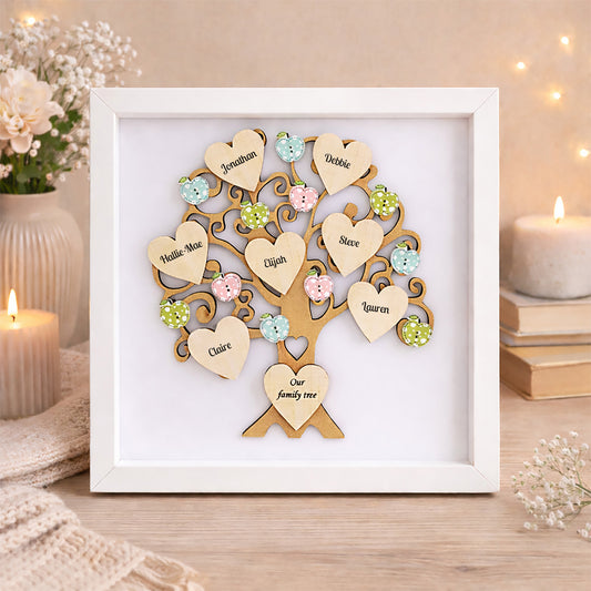Personalised Family tree with wooden printed hearts in a white frame on a decorative setting with candles and flowers.