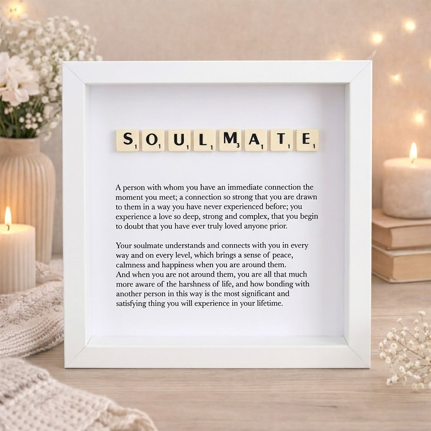 Framed Scrabble tile definition of 'soulmate' with decorative elements on a wooden surface.
