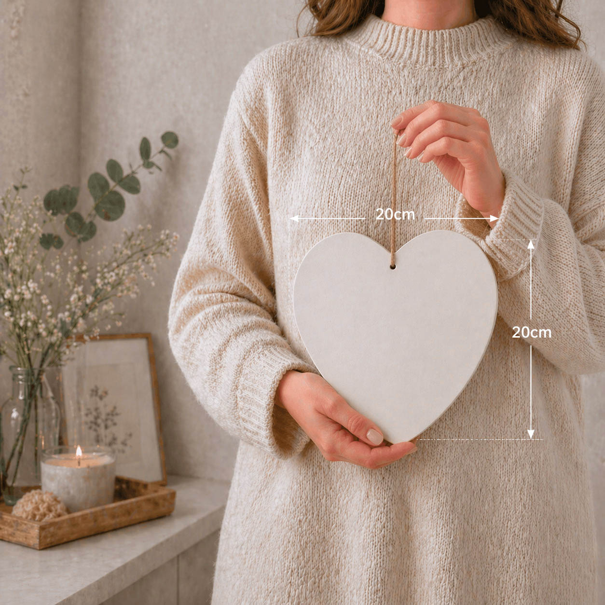 Woman holding a blank 20cm wooden heart plaque to show size