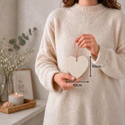 Woman holding a 10 cm by 10 cm heart plaque with dimension arrows showing its approximate size