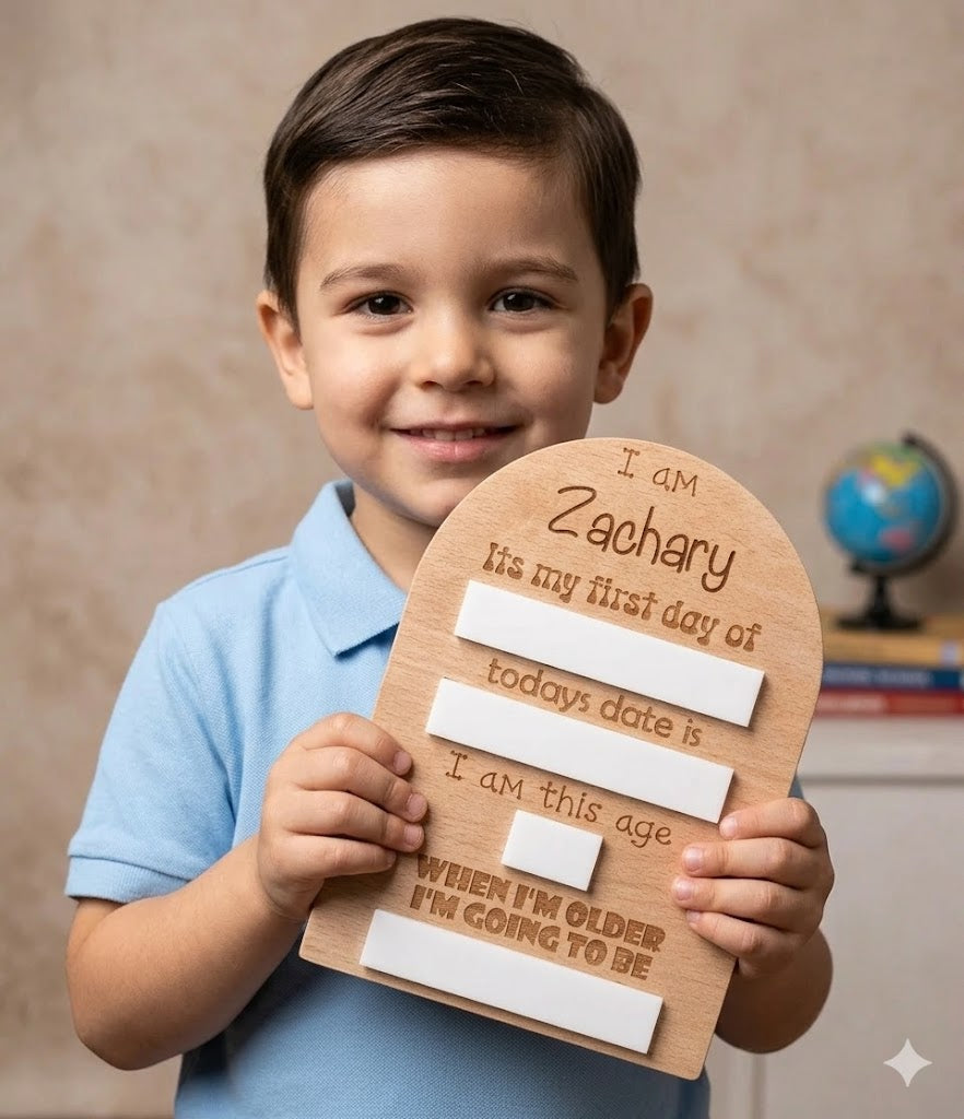 Child holding a wooden memory board with personalised text