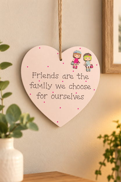 Friendship wooden heart plaque reading Friends are the family we choose for ourselves displayed on a warm neutral wall
