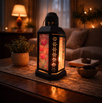 Personalised floral glass lantern glowing on a table in a cosy living room setting, custom engraved gift made in the UK