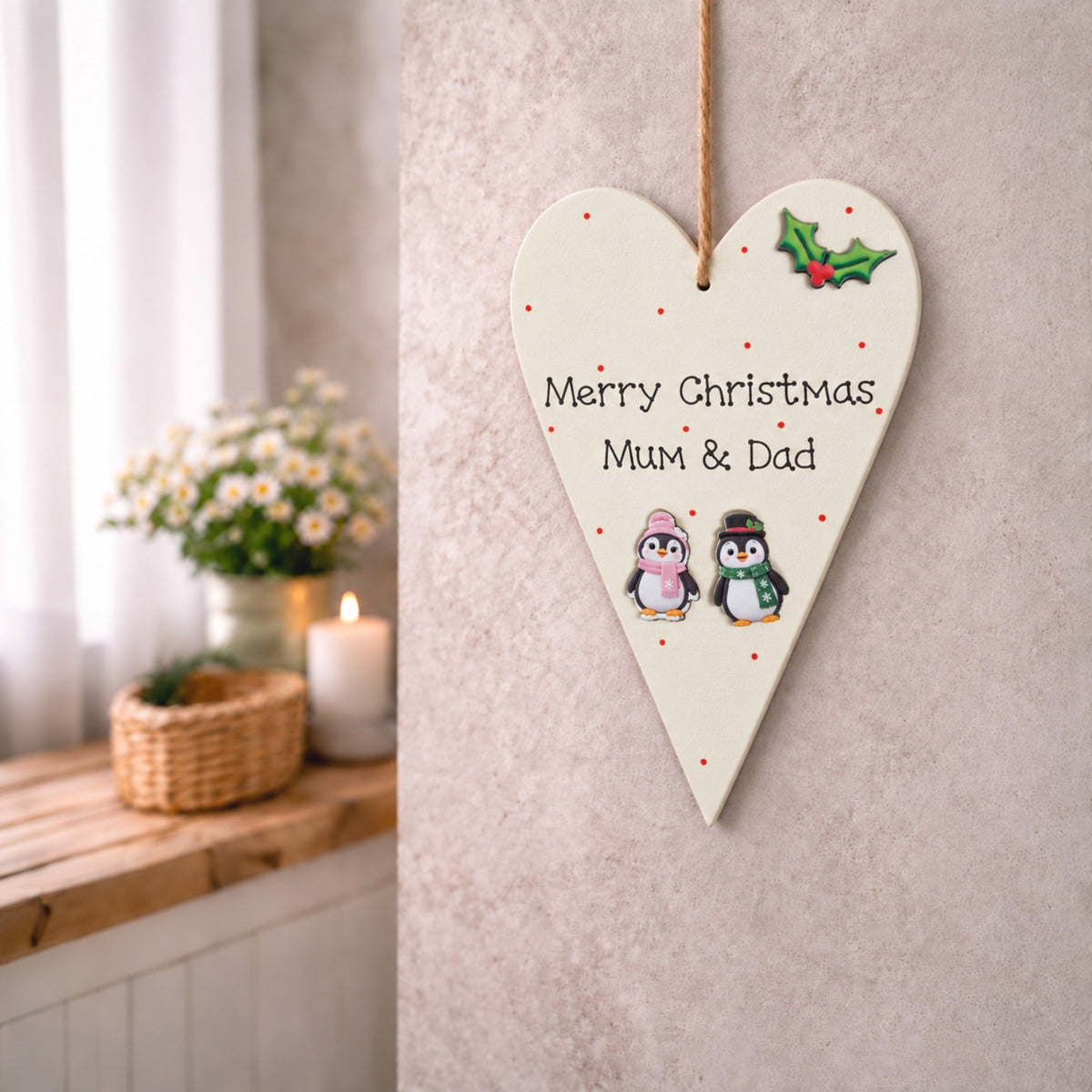 Merry Christmas Mum and Dad wooden heart plaque with Christmas penguins, hanging on a neutral wall