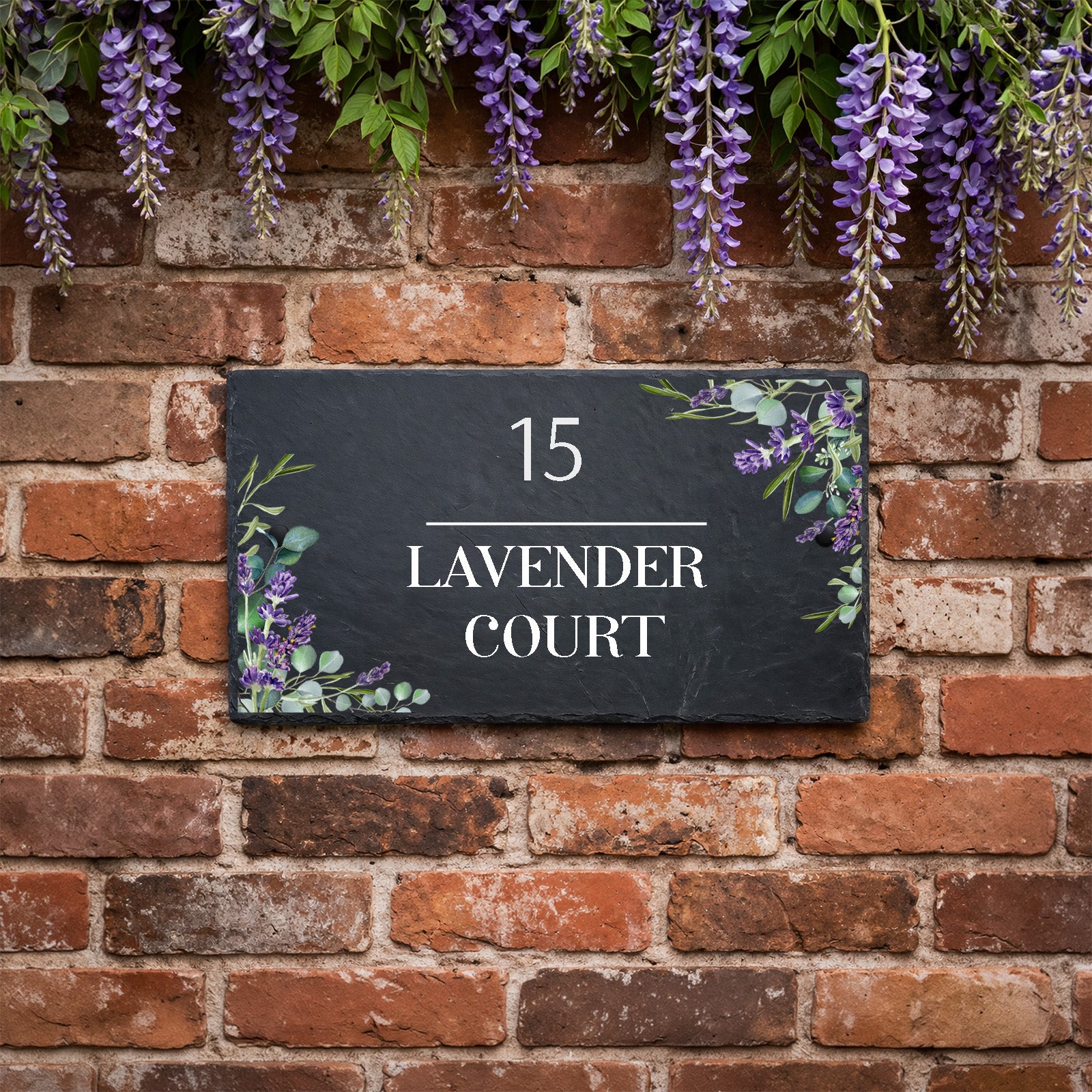 Personalised slate house sign with lavender design, house number and house name mounted on an exterior wall