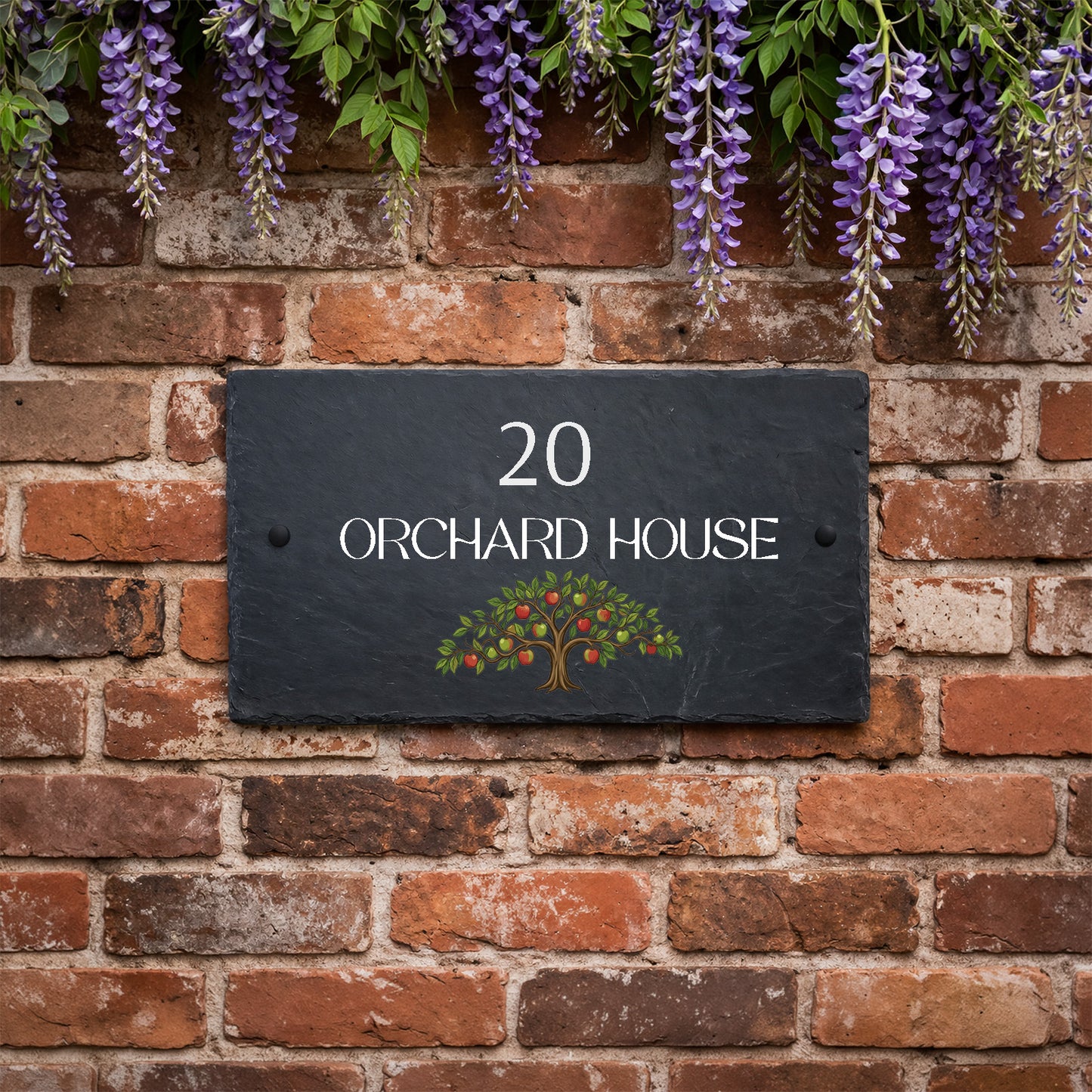 Personalised slate house sign with orchard apple tree design, house number and house name mounted on an exterior wall