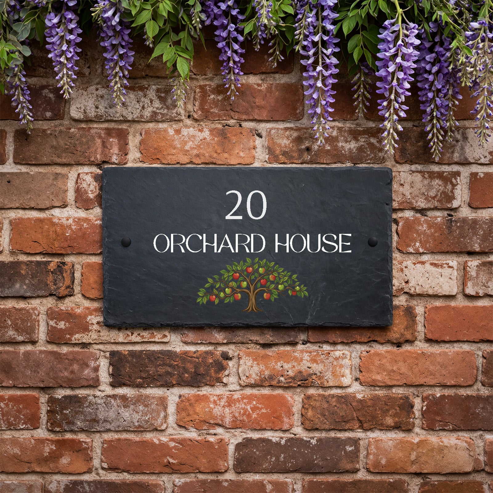 Personalised slate house sign with orchard apple tree design, house number and house name mounted on an exterior wall