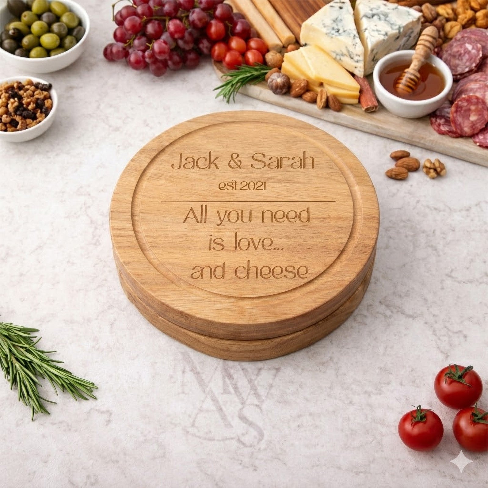 personalised cheeseboard closed with cheese and nibbles on worktop