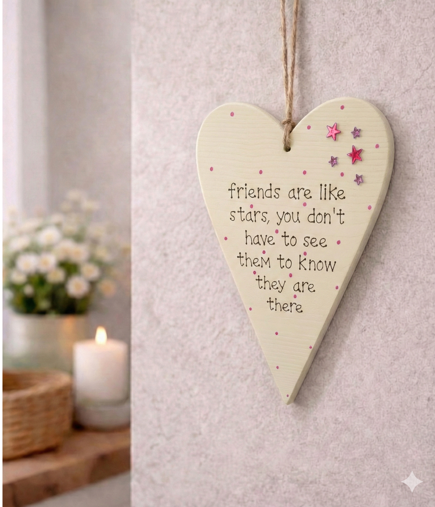 Heart-shaped wooden plaque with a quote friends are like stars with sparkly stars on a neutral beige background