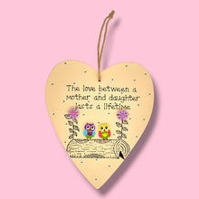 Load image into Gallery viewer, a wooden hanging plaque with the verse the love between a mother and daughter lasts a lifetime
